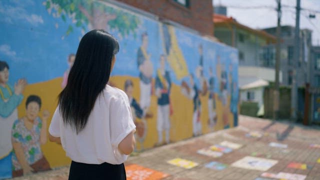 Young Woman Observing a Street Mural