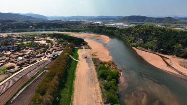 Tranquil river by traditional Korean house village