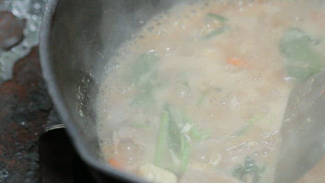 Vegetables and meat being stir-fried in a pan