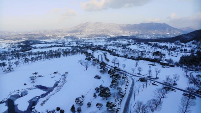 Snow-covered landscape with winding road