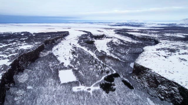 Snow-covered landscape with cliffs