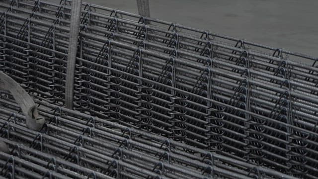 Stacked metal rods in a factory setting