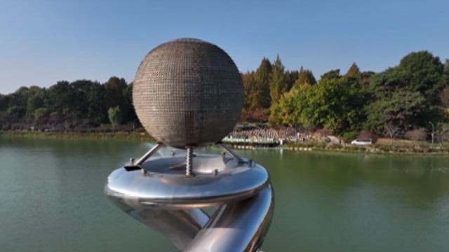 Park lake with spherical structures at day time