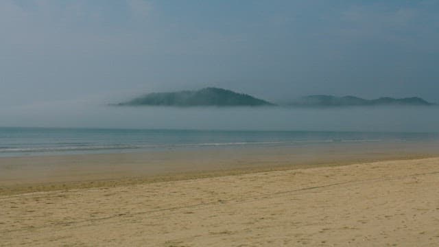 Misty Island View from Beach at Morning