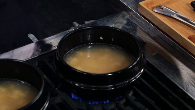 Big chicken being put in a hot pot