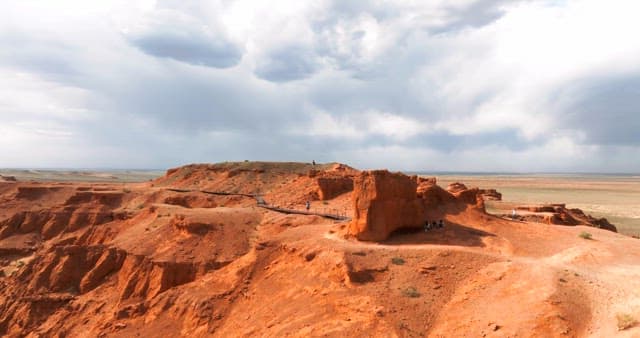 Expansive desert landscape with red cliffs