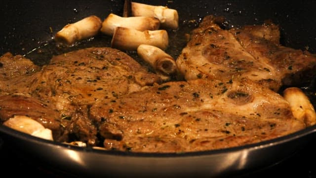 Cooking steak and pasta in a kitchen with delicious ingredients