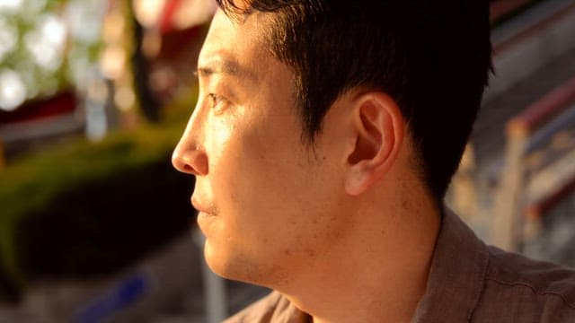 Man looking around at sunset