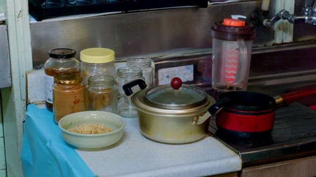 Various kitchen utensils and jars on a counter