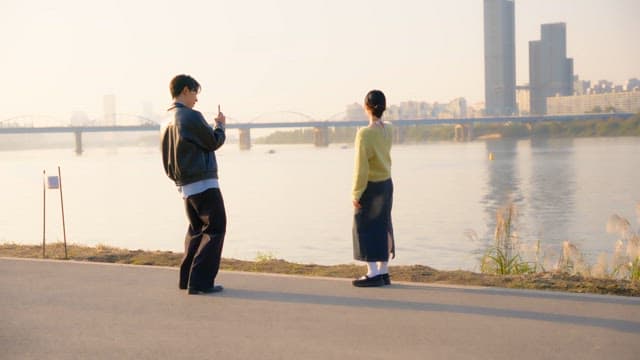 Couple taking pictures at the riverside