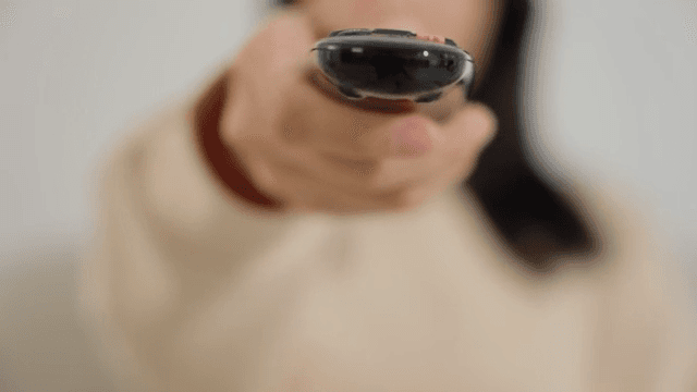 Woman operating a remote control