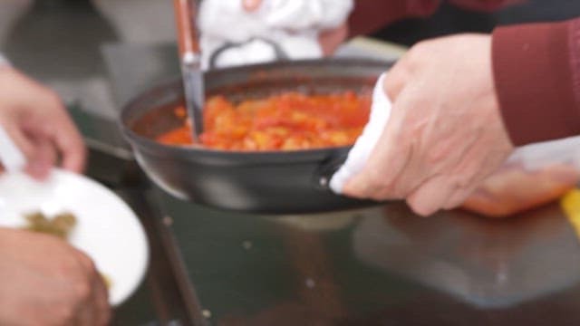 Finished Pork Stew Being Served in the Kitchen