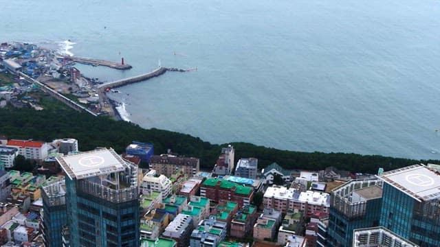 Coastal city with buildings with a helicopter landing pad