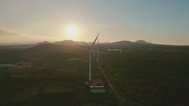 Wind turbines in a scenic landscape at sunset