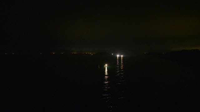 Fishing boat with its lights on while out night fishing