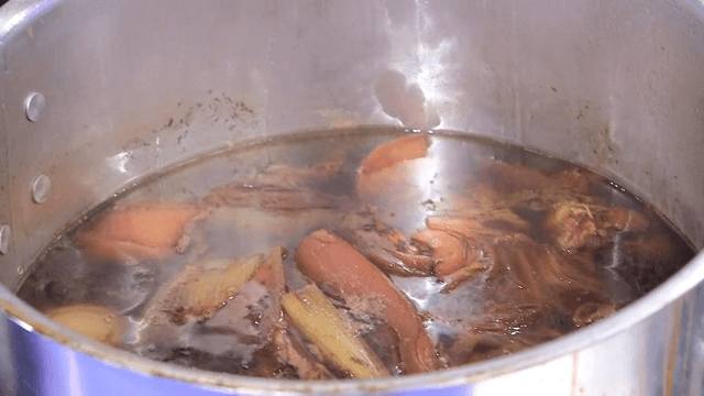 Boiled pork slices boiling in a pot
