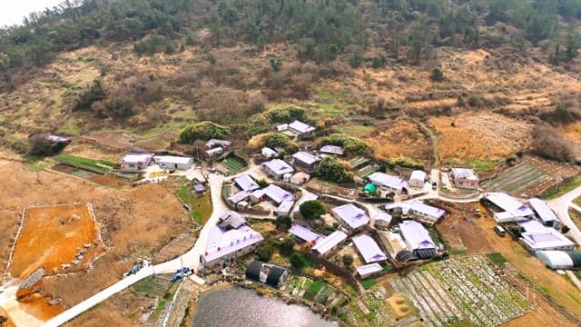 Rural village surrounded by fields and hills