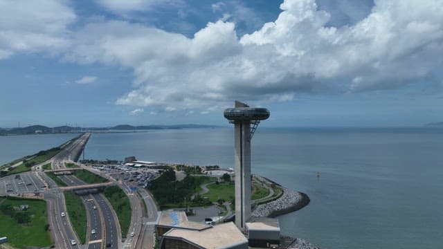 Coastal Highway and High-rise Observation Tower on a Cloudy Day