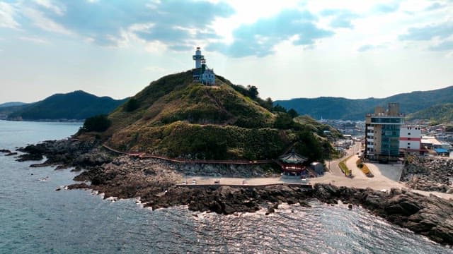 Lighthouse on a scenic coastal hill