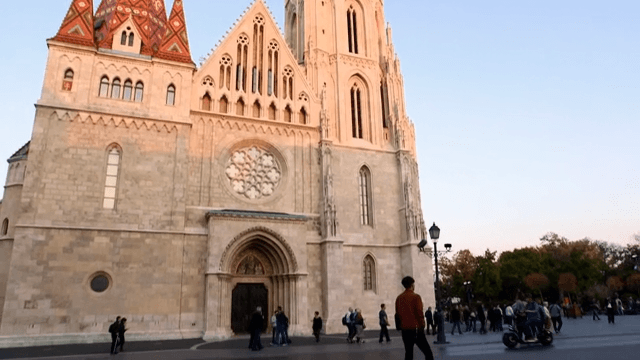 People Visiting the Historic Cathedral in the Evening