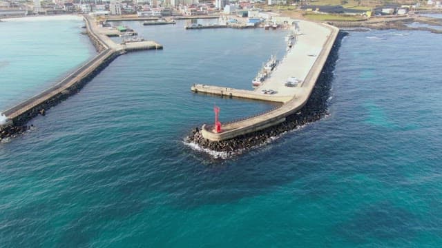 Coastal harbor with a red lighthouse