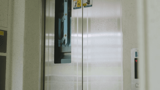 Man getting out of an elevator in an apartment building