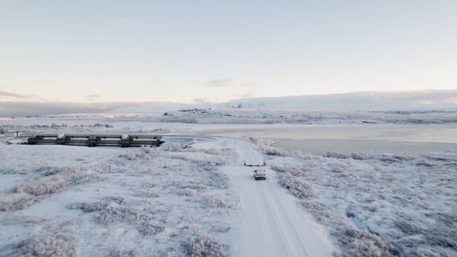 Snowy landscape with a car on a road