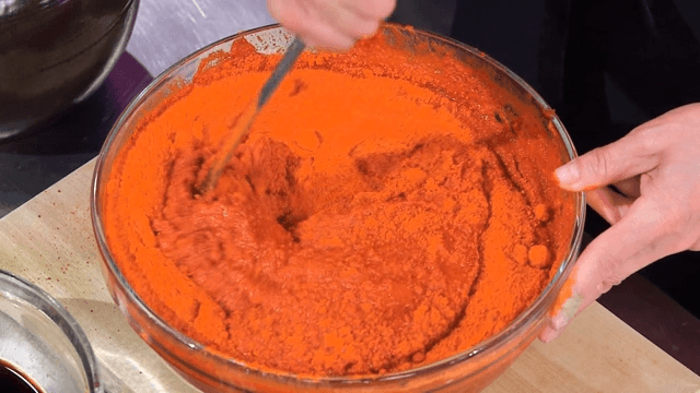 Pouring red pepper powder into a bowl