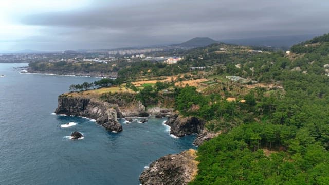 Coastal cliffs and distant cityscape