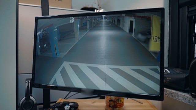 Screen of car explosion accident in parking lot shown on monitor