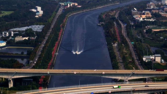 Boat sailing on a river under bridges