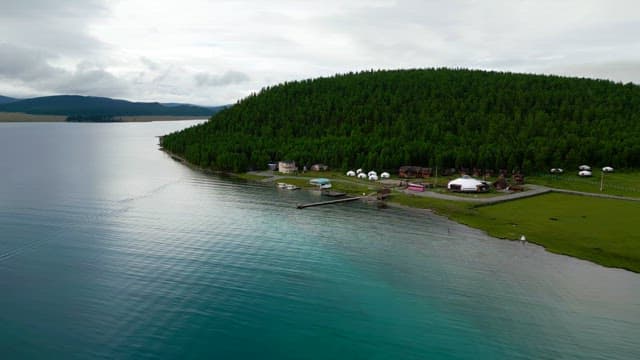 Serene lakeside village with lush forest