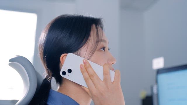 Woman talking on the phone in an office