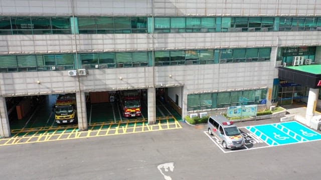 Fire station with fire trucks parked outside during the day