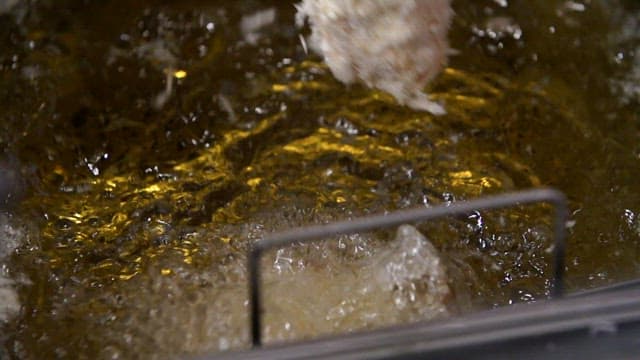 Frying breaded pork cutlet in hot oil