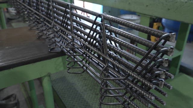 Metal rods being assembled in a factory