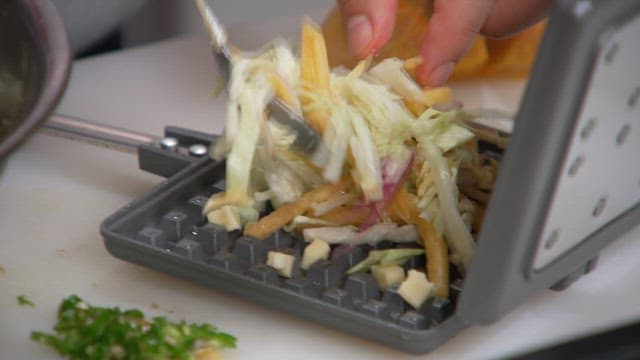 Cooking a vegetable-filled waffle with an iron