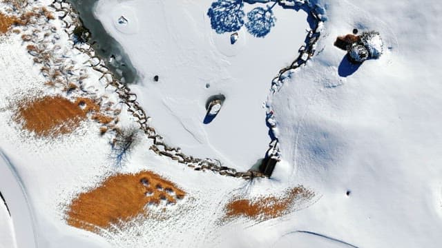 Snowy Landscape with Ponds and Trees