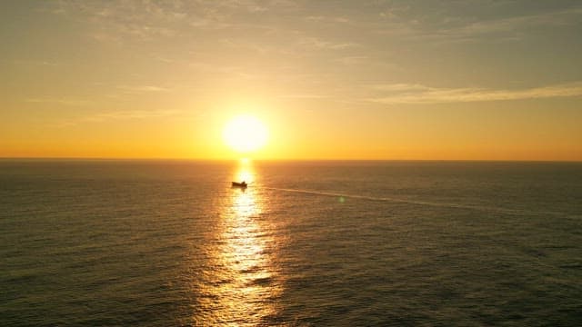 Sunset over the calm ocean horizon