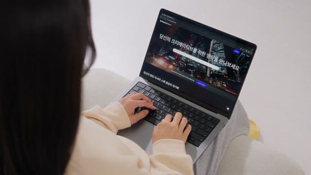 Woman browsing the internet on a laptop