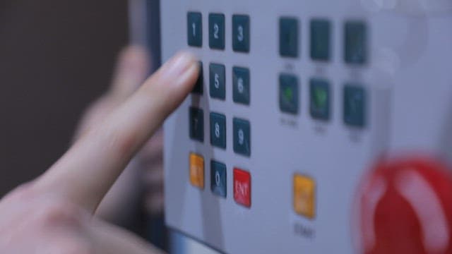 Operator Pressing Buttons on an Industrial Control Panel