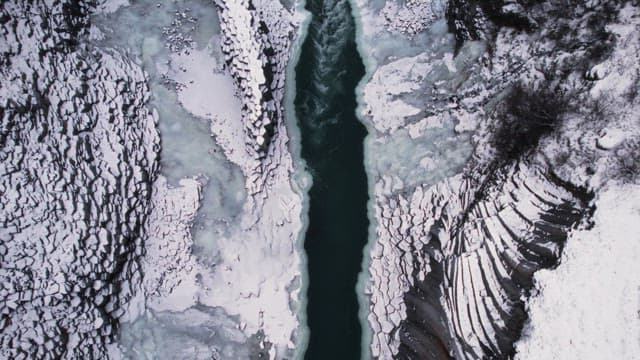 Snow-covered canyon with a frozen river