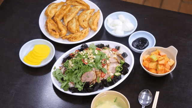 Plated dumplings and five-spice pork on the table