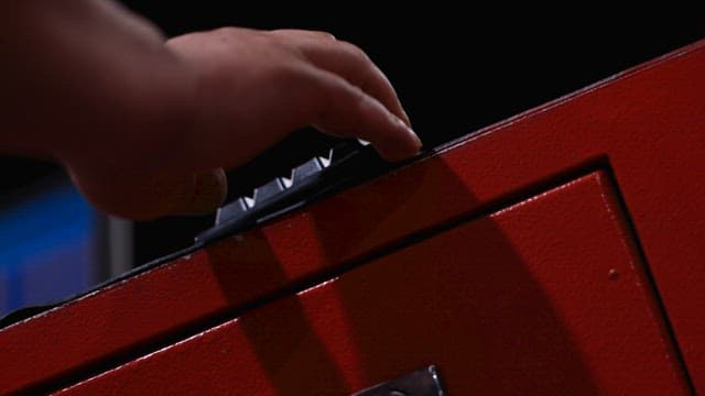 Fingers Carefully Pressing the Keypad