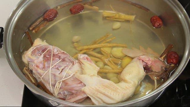Chicken added to the pot to make Samgyetang