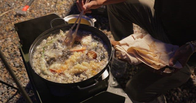 Outdoor Cooking of Fried Foods at Night