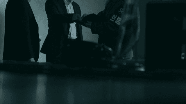 Military Policeman Investigating by Questioning in Dimly Lit Office