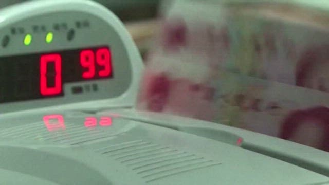 Chinese Yuan Being Counted on a Counting Machine of Bank