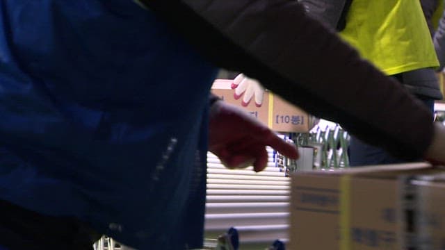 People Moving Boxes of Packed CSAT Question Papers