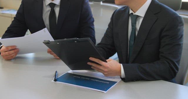 Businessmen reviewing documents at a table
